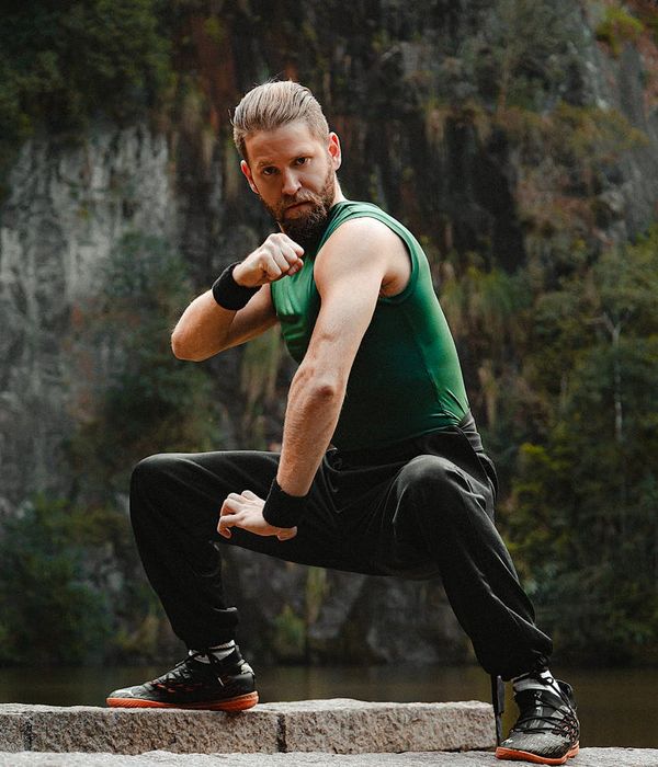 Athlete in a strong yoga warrior pose, showing balance and power.